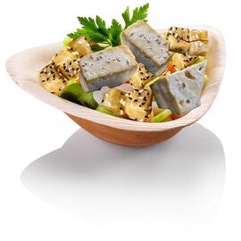 palm leaf bowl with pieces of tofu
